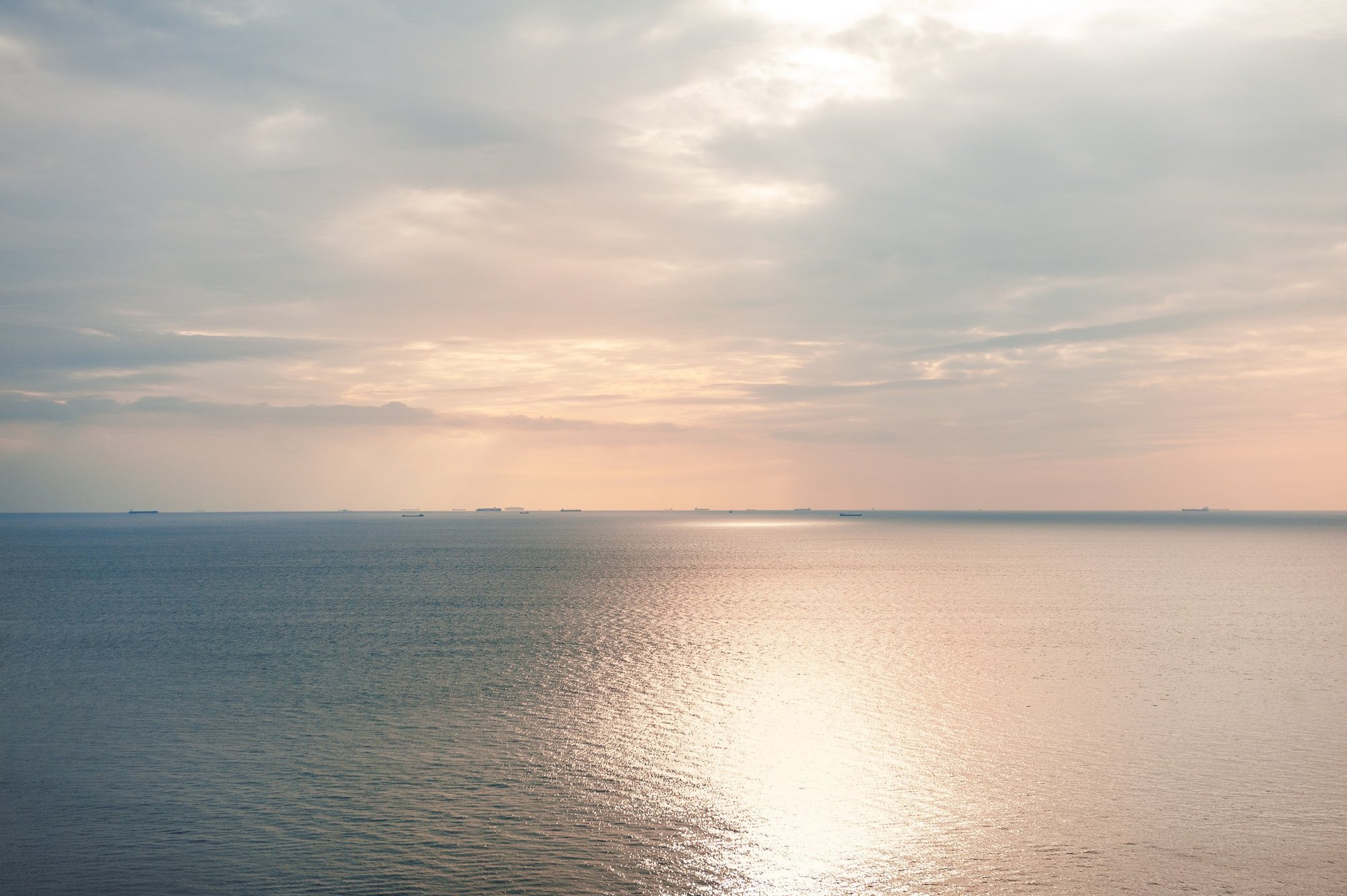 Calm sea horizon in soft golden light